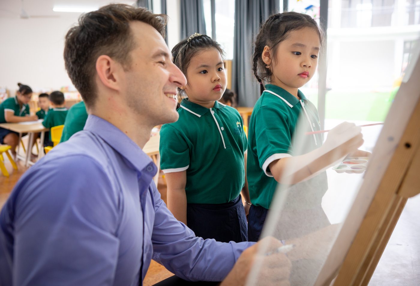 An international teacher painting with children