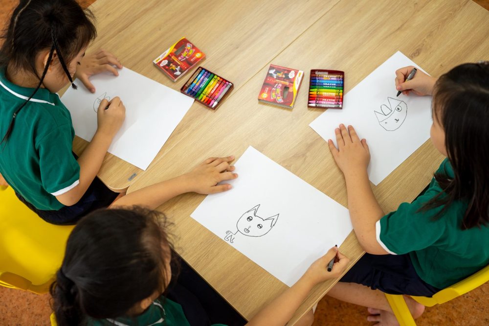 Children drawing with crayons